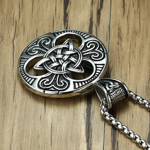 Macro view of vintage silver Celtic Knot pendant with heart patterns on a box chain