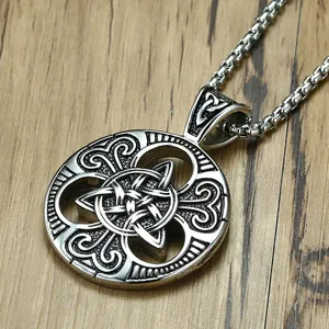 Retro stainless steel Celtic knot medallion necklace with black vintage finish on wood background