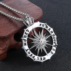 Macro detail of silver sun pendant with engraved words Respect, Honor, Power and Success