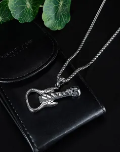 Detailed shot of retro silver skull guitar pendant with built-in bottle opener feature