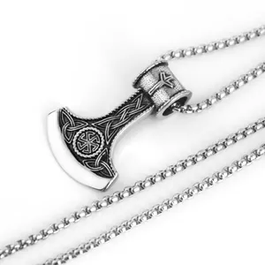 Macro detail of viking battle axe pendant with celtic knots and sun wheel engravings