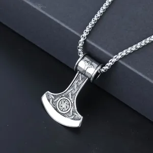 Macro detail of silver vintage Viking axe pendant with intricate Celtic knot patterns