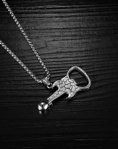 Macro shot of silver guitar skull pendant with bottle opener detail on dark wood background
