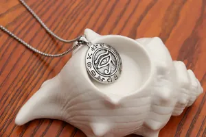 Close-up of Eye of Horus pendant with ancient Egyptian glyphs on a conch shell