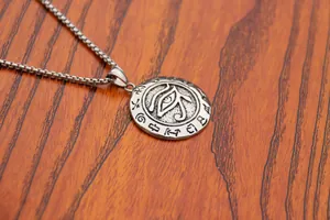 Macro view of vintage stainless steel necklace featuring Eye of Horus pendant and box chain