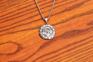 Detailed macro of vintage silver Eye of Horus pendant with ancient Egyptian symbols