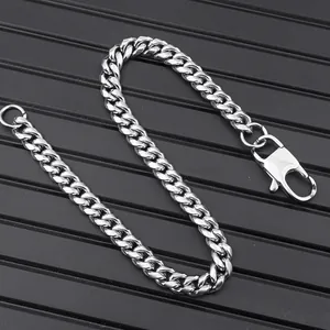 Macro shot of a silver stainless steel Cuban link chain with a secure lobster clasp