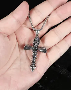 Detailed view of a gothic skull and spinal bone cross pendant in retro steel finish