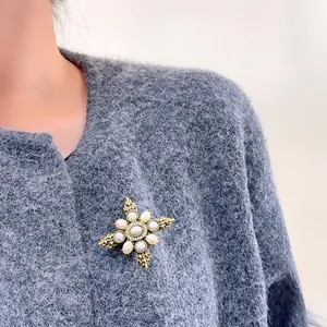 Vintage French court style gold star brooch with pearls on grey knit sweater