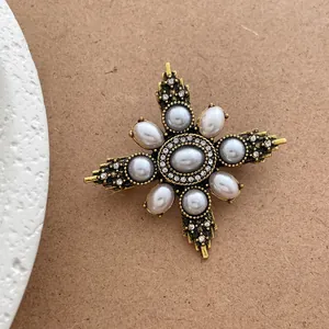 Vintage French court style golden brooch with central pearl and rhinestone cross star