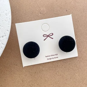 Detail of black velvet flocking ball earrings with S925 silver studs on jewelry card