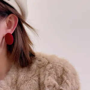 Elegant red flocked round stud earrings with vintage texture for autumn winter fashion