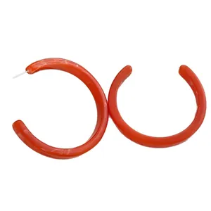 Retro C-shaped amber brown resin hoop earrings with elegant marble pattern on white background