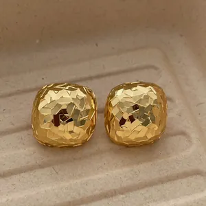18k gold plated square earrings with faceted shimmer surface on display tray