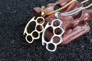 Detailed view of gold and silver knuckle duster pendants on metal bead chains
