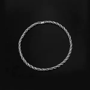 Macro detail of silver stainless steel rope chain necklace with a secure fold-over clasp