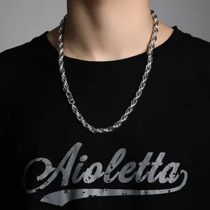 Close-up of a thick silver rope chain necklace with a rectangular plug-in clasp on neck