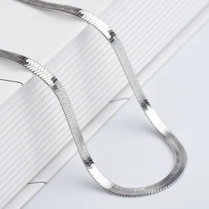 Mens silver flat herringbone snake chain necklace in stainless steel on white books