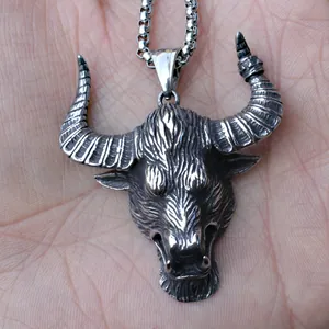 Detail of retro bull head pendant in punk style with stainless steel box chain