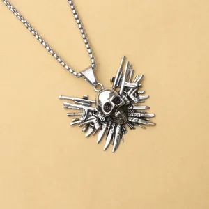 Macro view of punk skull pendant surrounded by guns and blades on a steel chain