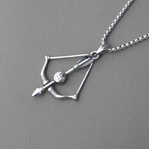 Detail of silver archer bow and arrow pendant with floral emblem on a box chain