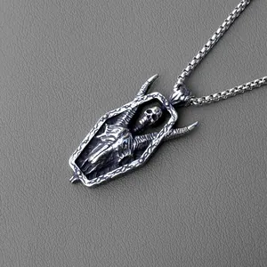 Macro detail of gothic skull pendant in coffin frame with vintage box chain texture