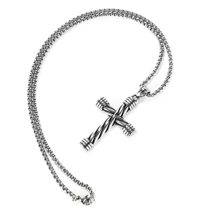 Macro shot of stainless steel cross pendant with twisted rope texture and box chain