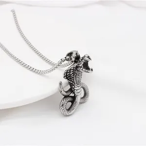 Macro detail of cobra pendant necklace with realistic scale textures and silver finish