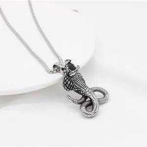 Detailed macro shot of hip-hop cobra pendant with intricate scales and metallic finish