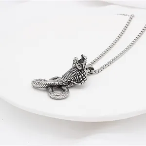 Macro shot of cobra snake pendant with detailed scales on a sturdy box chain