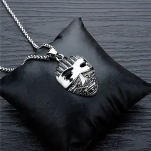 Vintage silver skull mask pendant necklace in punk style on dark leather display