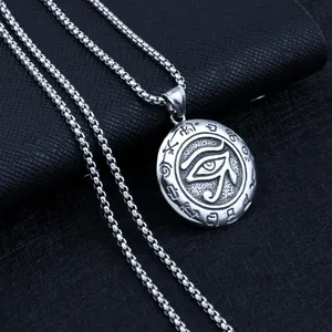Macro shot of silver Eye of Horus pendant on vintage box chain over black leather