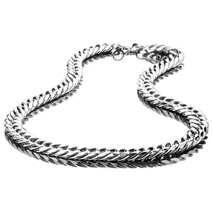 Detailed macro view of a silver stainless steel cuban link chain with a lobster clasp