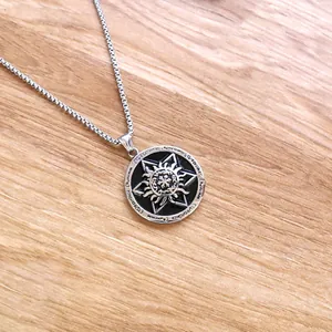 Close-up of a silver hexagram star pendant with black enamel inlay on wood texture