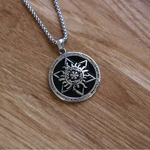 Macro view of vintage sunburst pendant with runic engravings on a sturdy box chain