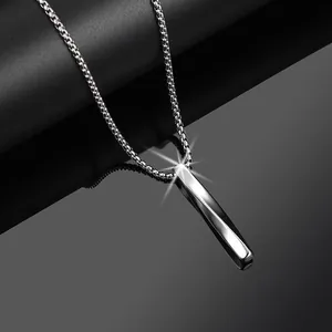 Close-up of a silver twisted rectangular pillar cross pendant on a Venetian box chain