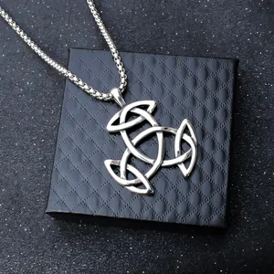 Polished silver stainless steel Celtic knot pendant necklace on a black jewelry box