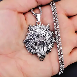 Vintage punk wolf head pendant necklace in stainless steel shown in palm for size