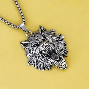 Macro view showing detailed texture of vintage silver wolf head pendant and box chain