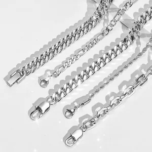 Detail shot of five diverse silver stainless steel chains including Cuban and Figaro links