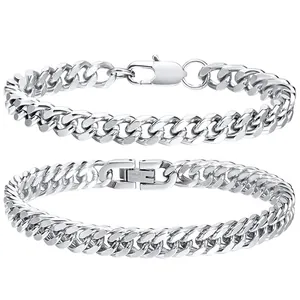 Detail showing two silver stainless steel Cuban link chain bracelets with different clasps