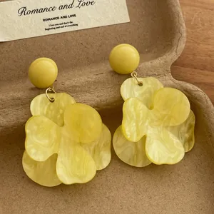French vintage oversized yellow floral earrings with marble texture petals in a gift box