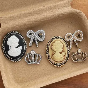Vintage brooch set with cameo portraits, pearl bows, and rhinestone crowns for suits