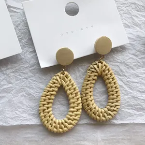 Bohemian woven rattan drop earrings with wooden studs in a natural beige finish