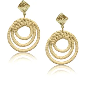 Bohemian triple rattan hoop earrings with gold hammered diamond-shaped studs on white