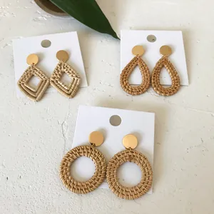 Detailed macro shot of bohemian rattan earrings in geometric diamond and drop shapes