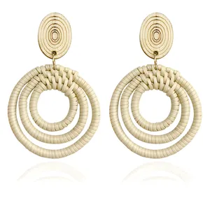 Ethnic bohemian drop earrings with wood grain studs and woven straw triple circle pendants