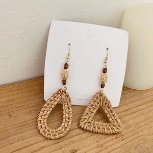 Bohemian rattan drop earrings with handmade wooden beads and woven geometric shapes