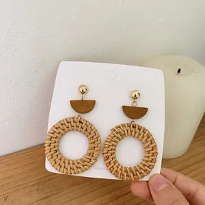 Bohemian woven rattan hoop earrings with vintage wood accents and golden studs
