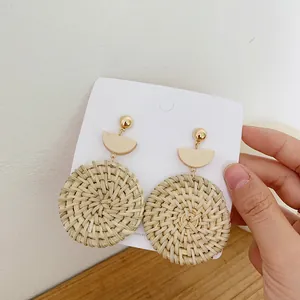 Bohemian style oversized round rattan drop earrings with golden stud on card board
